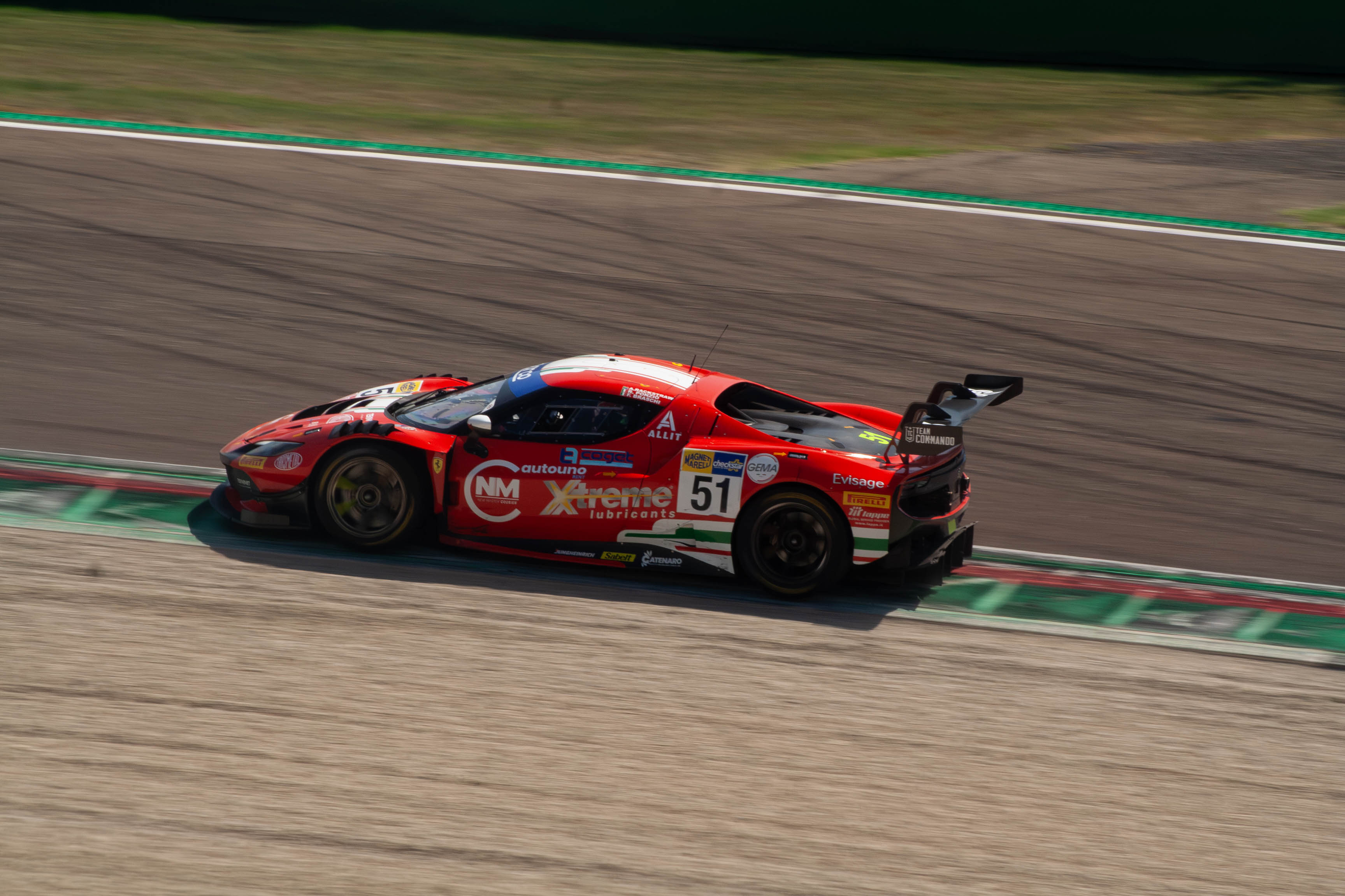 Side view of Ferrari 296 GT3 #51 in red livery cornering at Imola Circuit
